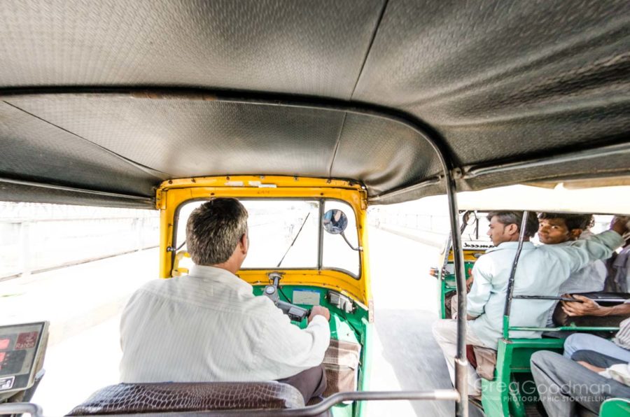 A passenger's view of an tuk tuk driving across a bridge in India