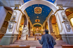 A local prays at the Santuario de la Virgen del Socavon in Oruro, Bolivia