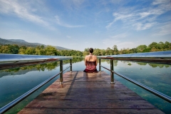 My wife, Carrie, sits at the end of a dock in Chiang Mai University