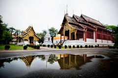 Wat Phra Singh reflects in a puddle during an early morning visit