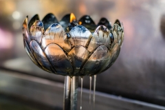 Oil drips from a prayer vessel at Wat Doi Suthep