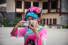 Gotta love the irony ... a woman dressed in traditional Chinese clothes holding two ultra-modern cell phones