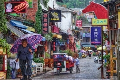 A grandmother walks through the Yangshou market in Guangxi, China