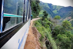 A bus teeters near the side of a road in southern Ecuador
