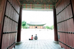 Tourist take a break from the heat while visiting the Junghwajeon Building at the Deoksugung Palace in Seoul, South Korea