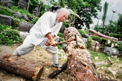 This man is in the process of carving a totem pole with an axe at the Hahoe Village in Andong, South Korea