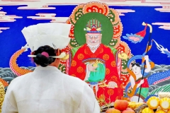 A Mudang (ceremonial priest) prays to the Dragon King during an exorcism in South Korea