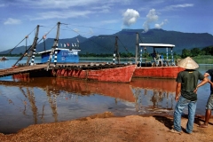 Two local men wait for a ferry boat to Champasak, Laos