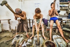 Workers pound gold leaf at the Golden Rose in Mandalay, Myanmar (Burma)