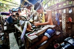 A worker at the Mandalay Jade Market polishes precious stones