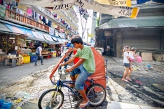 A pedicab driver races through the Baclaran Market in Manila, Philippines