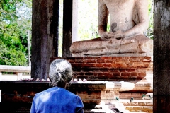 A woman prays to the Samadh Buddha in Anuradhapura - one of the Ancient Cities in Sri Lanka