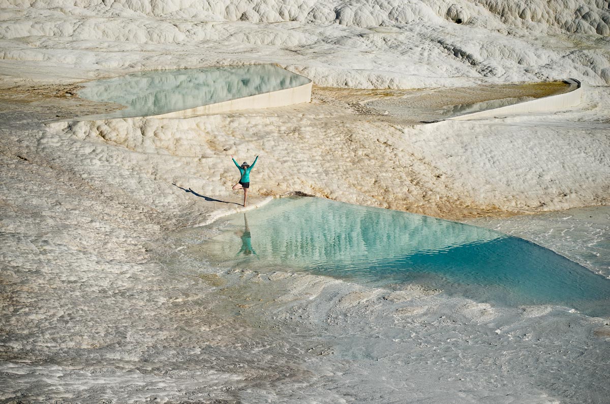 My wife does a yoga pose at the Pamukkale Cascades in Denizli Provence, Turkey