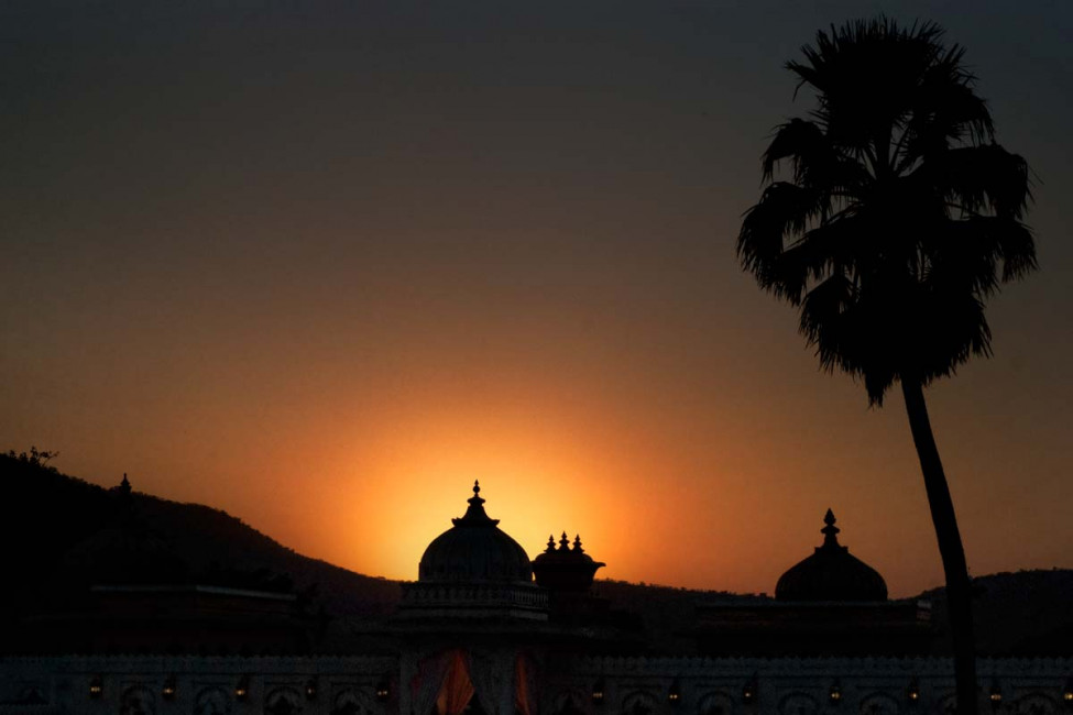 Sunset over a floating palace in Udaipur, India