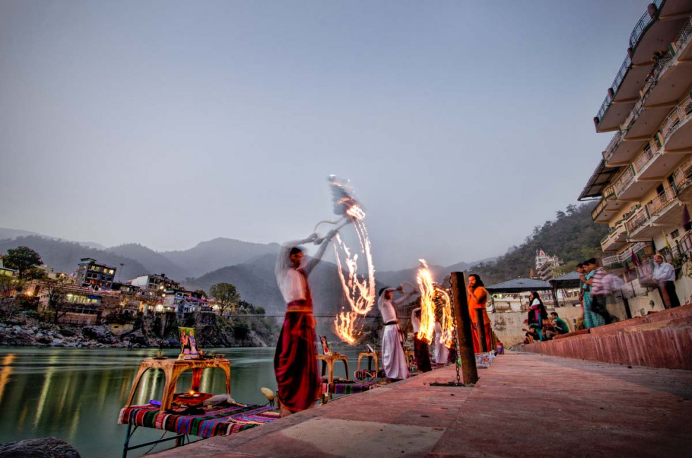 Devotees perform a puja (religious ceremony) alongside the Ganges River in Rishikesh, India