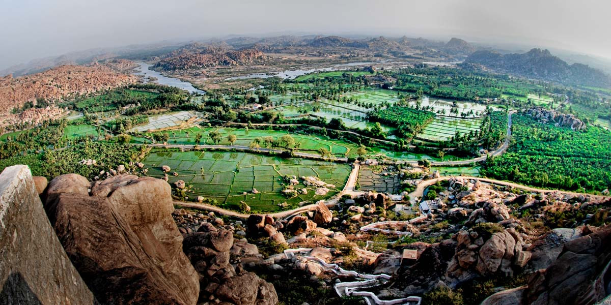 Rice fields and dirt roads cover the countryside near Hampi, India