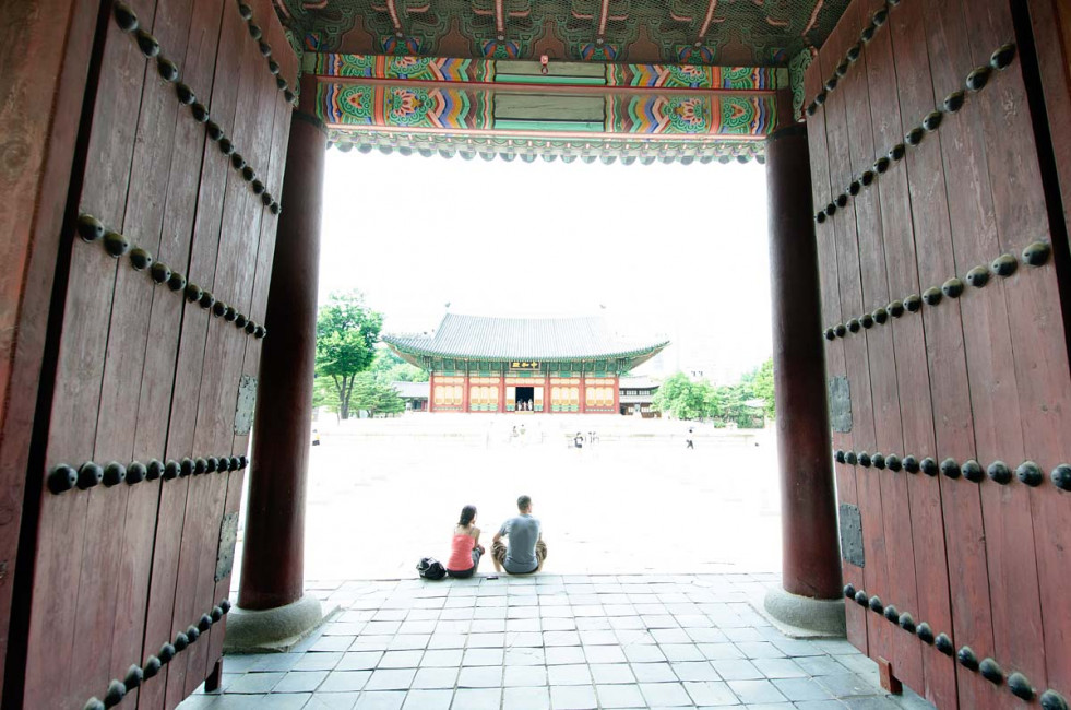 Tourist take a break from the heat while visiting the Junghwajeon Building at the Deoksugung Palace in Seoul, South Korea