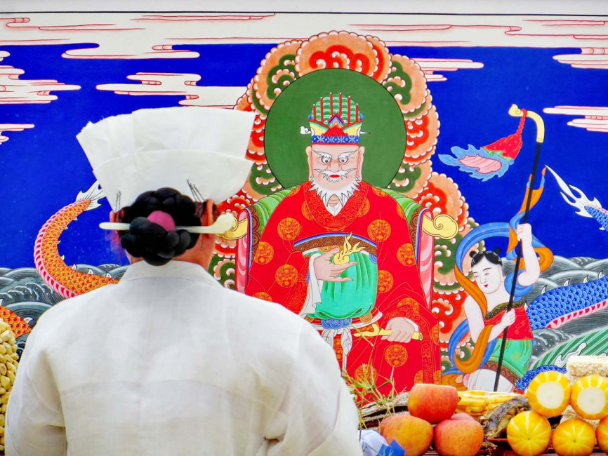 A Mudang (ceremonial priest) prays to the Dragon King during an exorcism in South Korea