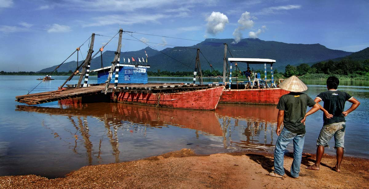 Two local men wait for a ferry boat to Champasak, Laos