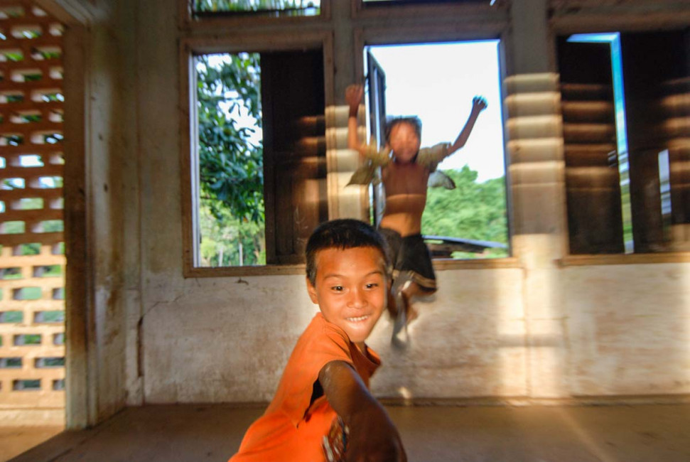 Local kids ham it up for the camera at the abandoned Groupe Scolaire de Champassak