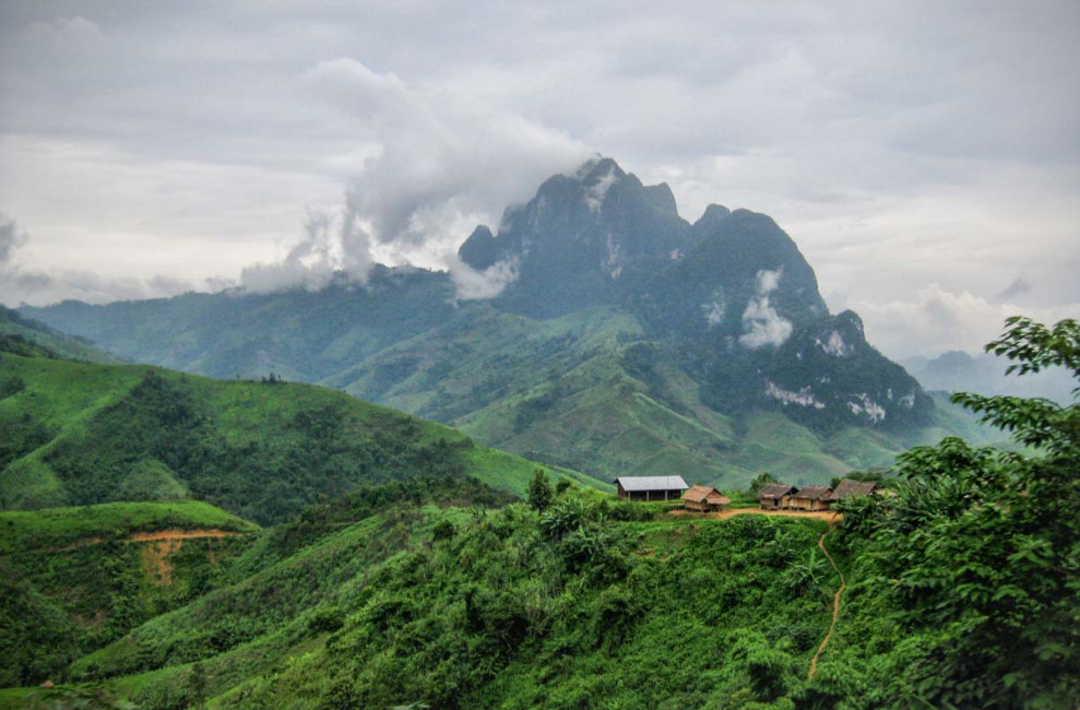 The Laos countryside is filled with lush green mountains, small homes and lots of agriculture