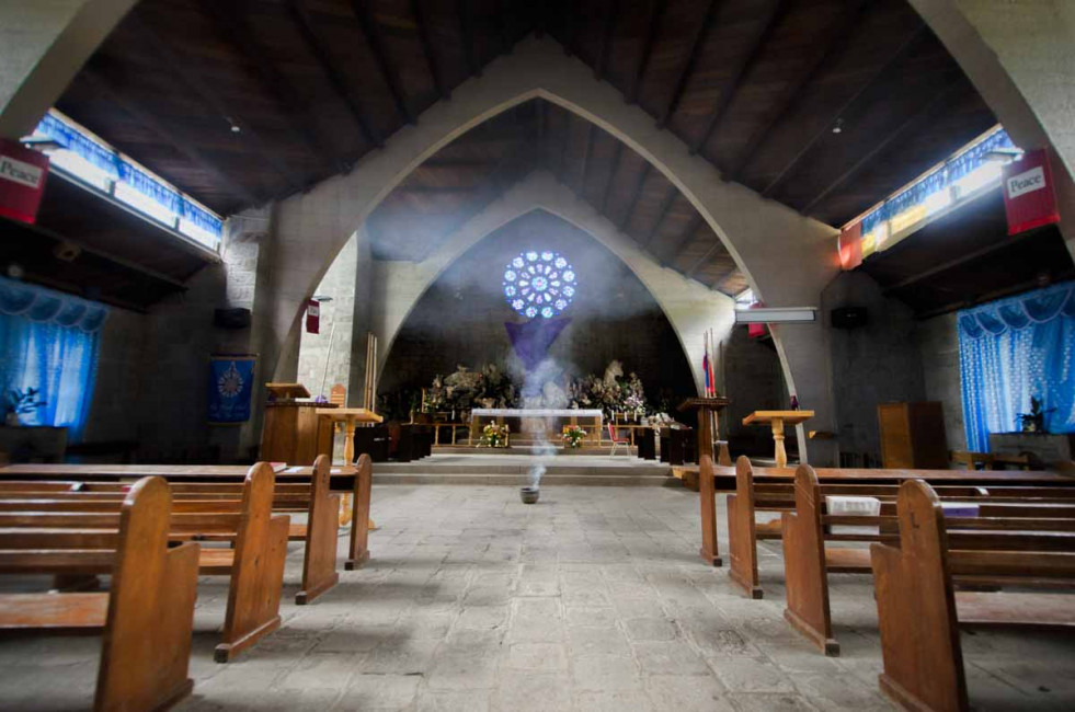 Ceremonial smoke burns at the Church of St. Mary the Virgin in Sagada, Philippines.