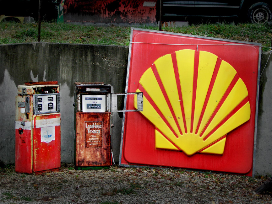 Abandoned gas station pumps and signs adorn the sides of Route 66