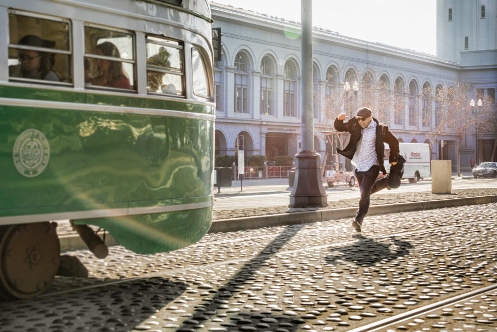 Running for a historic F-line MUNI train alongside the Ferry Building in San Francisco, California