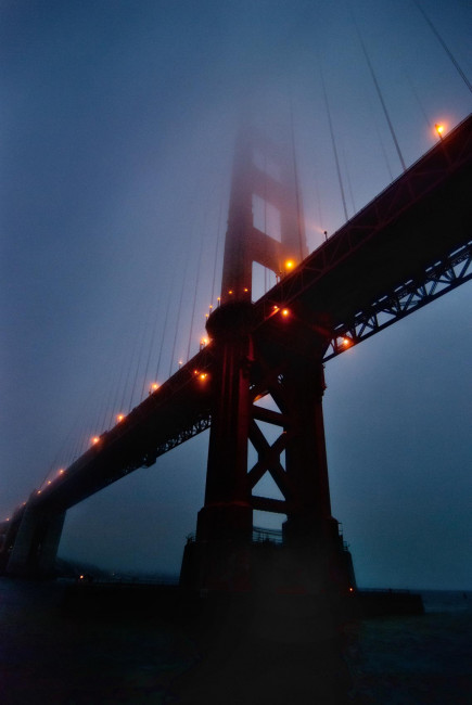 A foggy blue hour beneath the Golden Gate Bridge