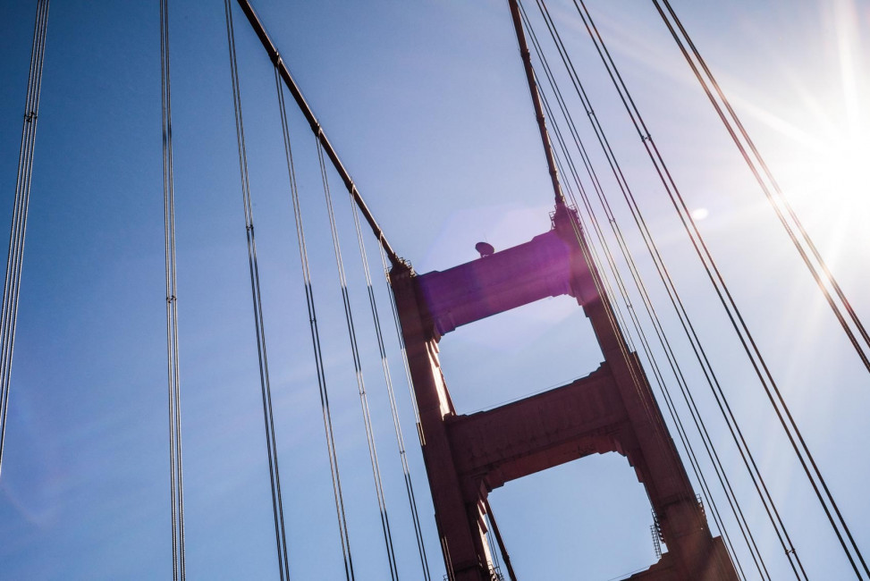 Looking up at the Golden Gate Bridge, while driving underneath it's iconic spires