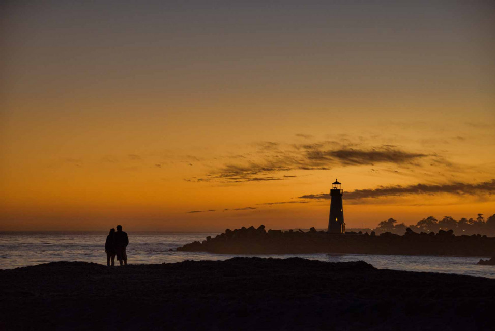 Sunset over the Walton Lighthouse at Twin Lakes State Beach in Santa Cruz, CA