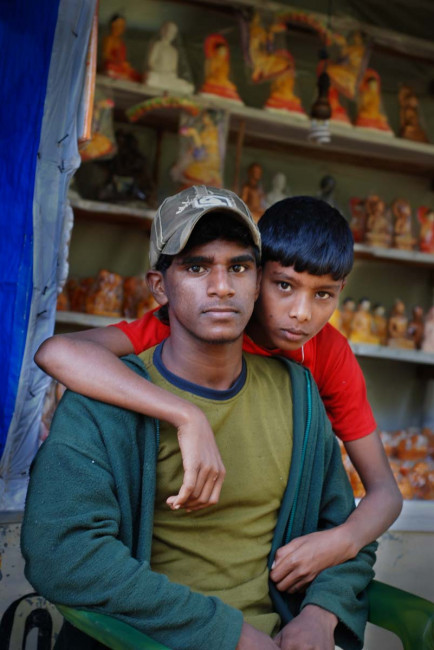A father-son team sells souvenirs to tourists descending from Adam's Peak
