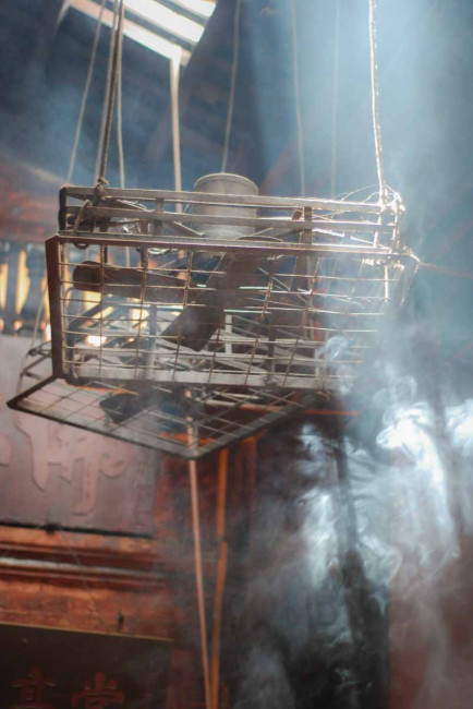 Incense smoke fills the Jade Emperor Pagoda in Ho Chi Min City, Vietnam