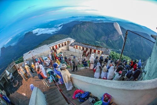 Travelers and devotees greet the dawn from atop Adam's Peak in Sri Lanka