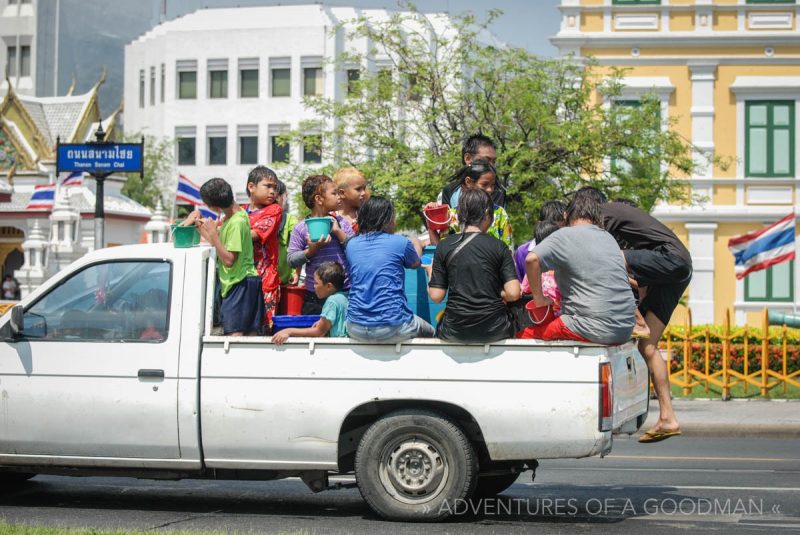 A pickup truck loaded with people celebrating Songkran in Bangkok