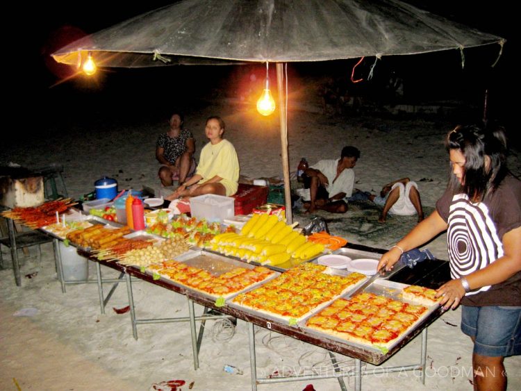 Locals selling pizza, corn, hot dogs and other snacks