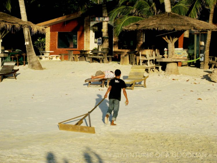 A young boy combs the beach the morning after the Full Moon Party