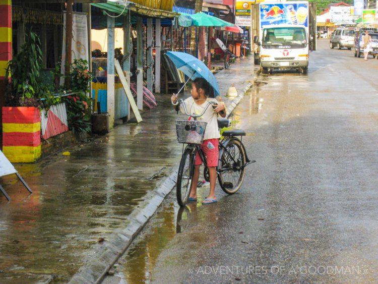 A little girl rides a bicycle in Laos