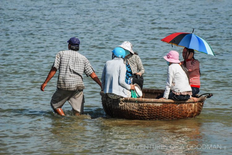 Locals go for a ride in a coracle bamboo round boat in Nah Trang, VietNam