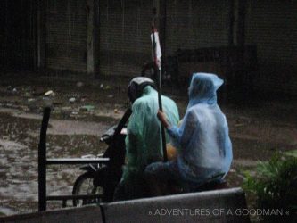 In the middle of a monsoon this poor woman had to leave a hospital on the back of a motorcycle while holding an IV in Kratie