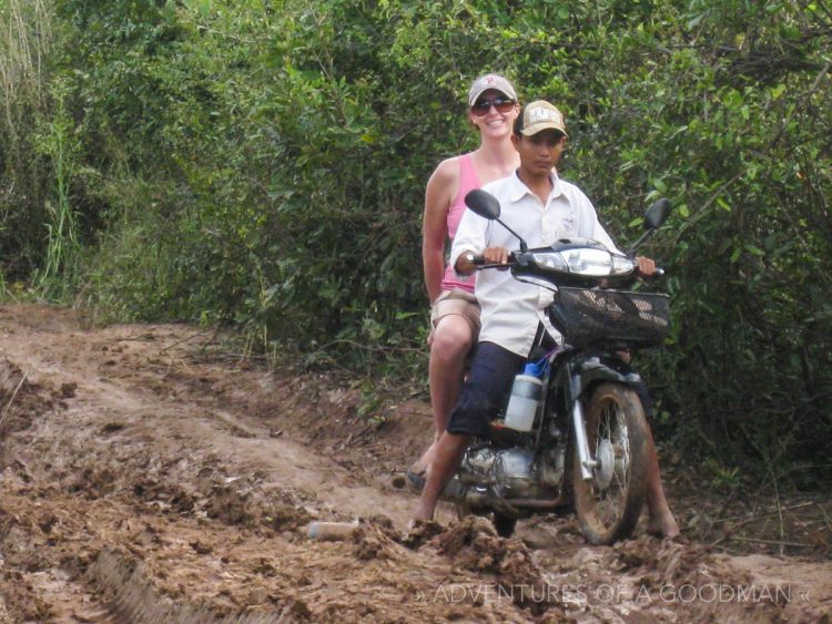 Carrie and her driver on the muddy road to Kampong Phluk
