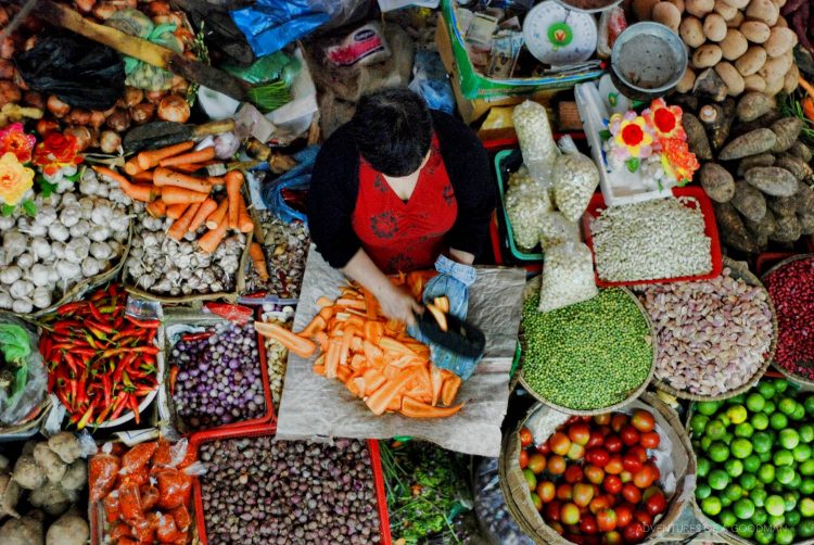 A produce vendor in the Da Lat market, VietNam