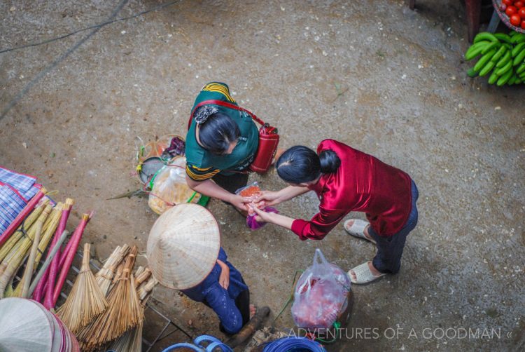 Locals conduct a transaction at the Sapa market