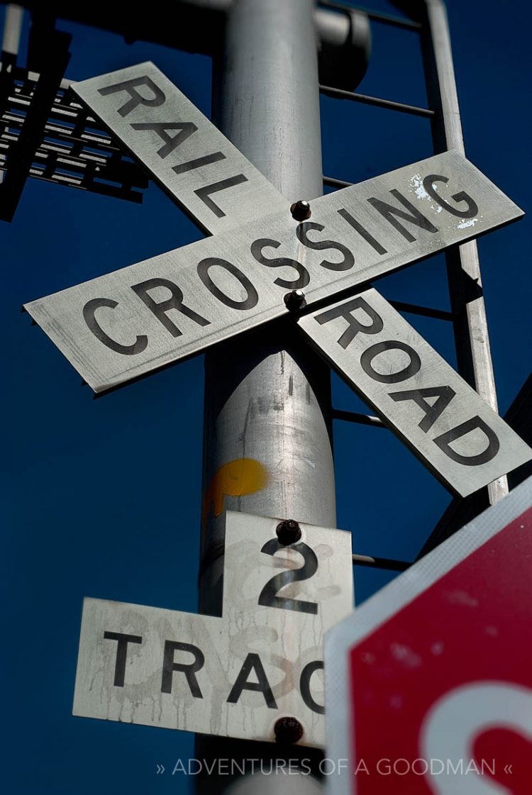 A railroad crossing sign plus a little bit of a stop sign near 16th Street in Oakland, California