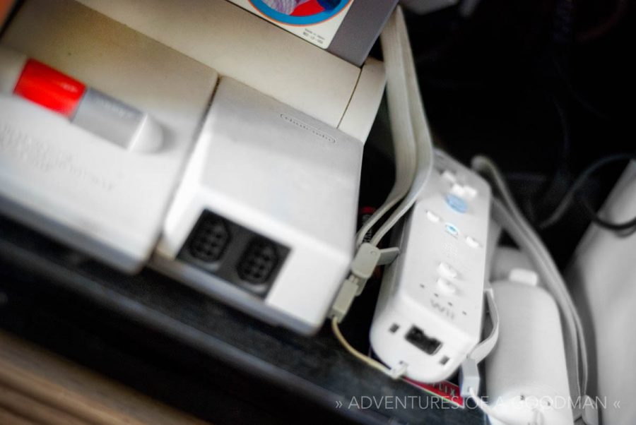 A Nintendo Entertainment System next to a pair of Wii remotes