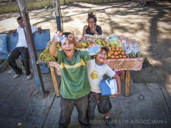 Kids sell fruit and pastries on the side of the road in Managua, Nicaragua