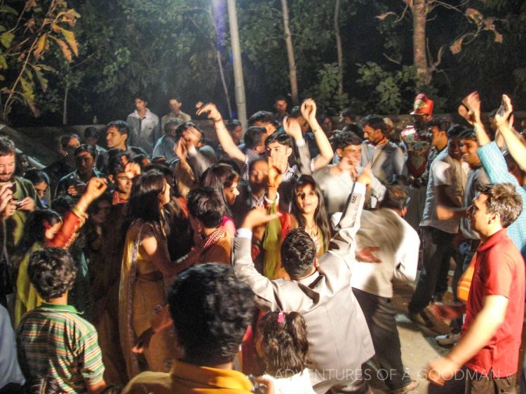 Dancing in the streets as Sanjay enters in a mobile throne