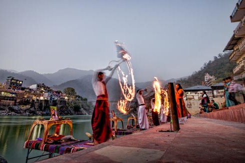 Local holy men perform a puja alongside the Ganges (Ganga) River in Rishikesh, India