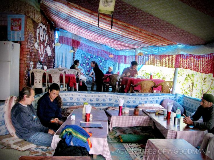 Tourists relax and eat inside the Munchies Cafe in Bahgsu, India