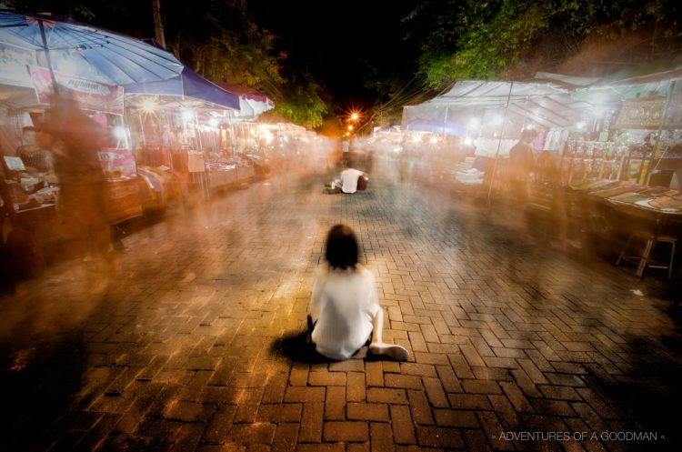 A 30 second exposure of a beggar in the Chiang Mai Sunday Walking Street Market